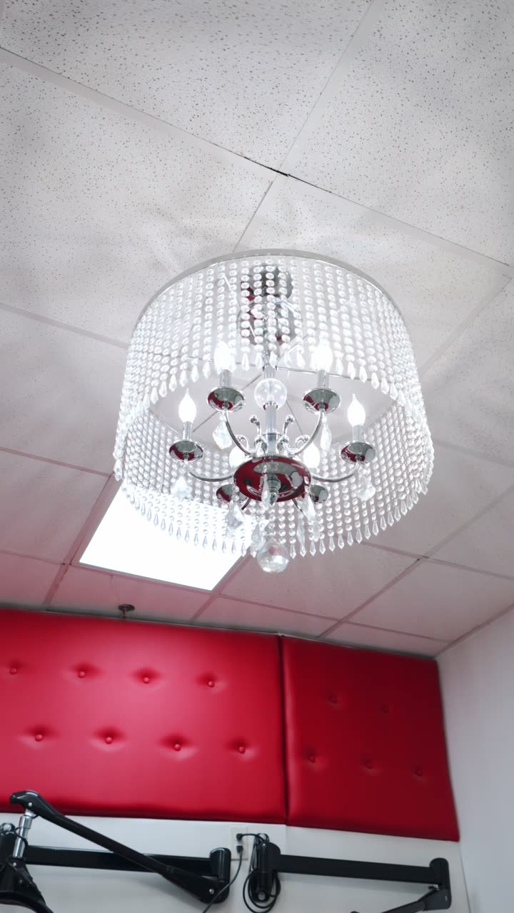 Crystal chandelier above the red tufted lounge