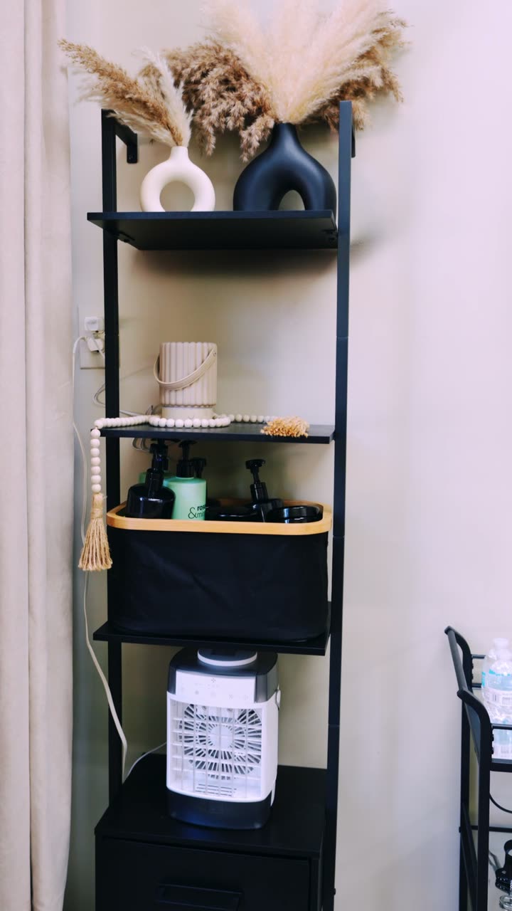 Suite shelving styled with pampas grass, decor and products